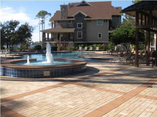 1105 Prospect Promenade, Unit 101 Panama City Beach, FL 32413 - Photo 15 of 27 a front view of a house with a yard