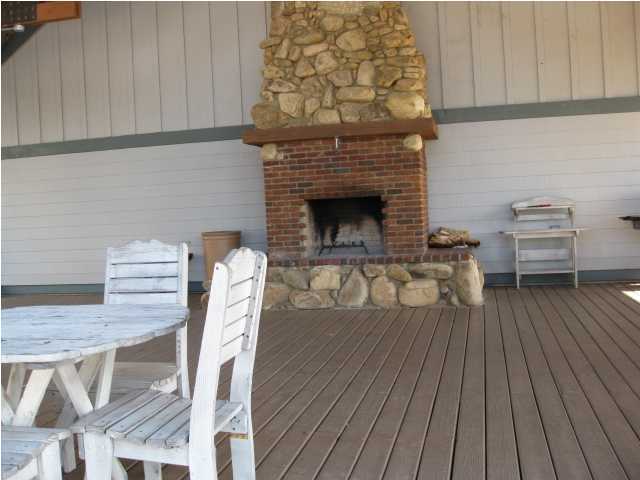 1105 Prospect Promenade, Unit 101 Panama City Beach, FL 32413 - Photo 23 of 27 a living room with furniture a wooden floor and a fireplace
