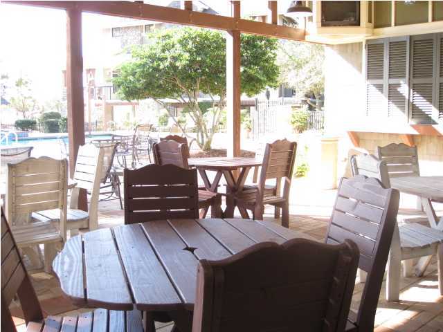 1105 Prospect Promenade, Unit 101 Panama City Beach, FL 32413 - Photo 25 of 27 a view of a dining room with furniture window and outside view