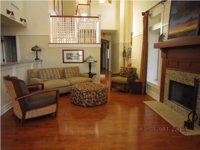 1105 Prospect Promenade, Unit 101 Panama City Beach, FL 32413 - Photo 4 of 27 a living room with furniture and a fireplace