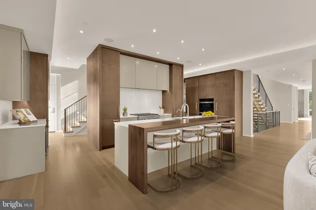 a kitchen with stainless steel appliances kitchen island granite countertop a refrigerator a sink a stove and a wooden cabinets