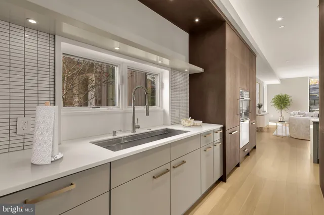 a spacious bathroom with a sink and a large mirror