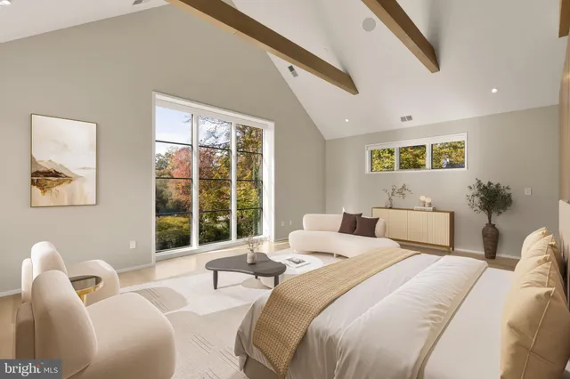 a bedroom with two beds and a large window