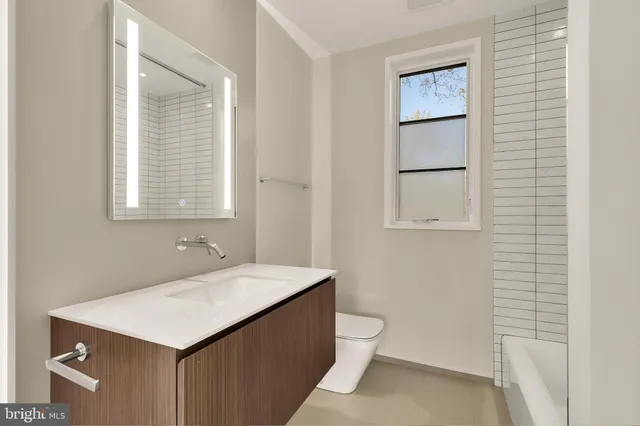 a bathroom with a sink toilet and vanity
