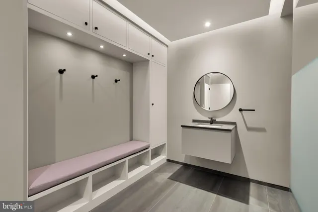 a living room with stainless steel appliances granite countertop furniture and a mirror