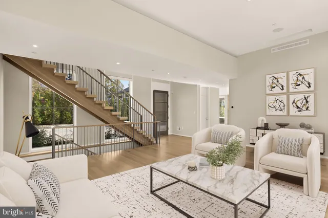 a living room with furniture and a dining table