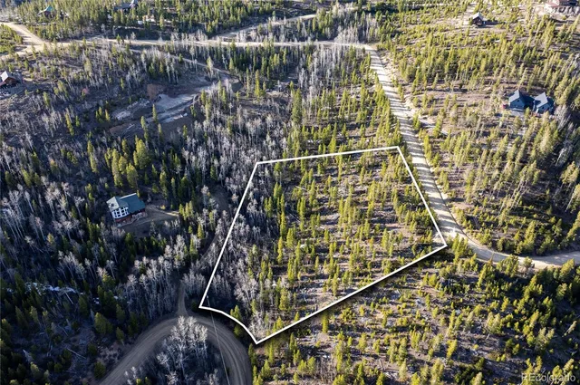 an aerial view of a house with swimming pool and garden
