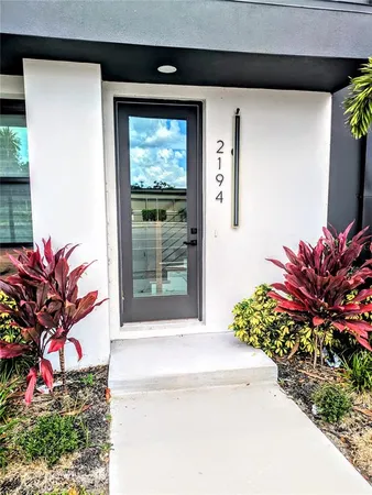 a potted plant sitting in front of a house