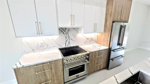 a kitchen with a stove and a refrigerator