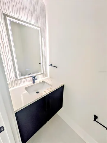 a bathroom with a sink vanity and a mirror