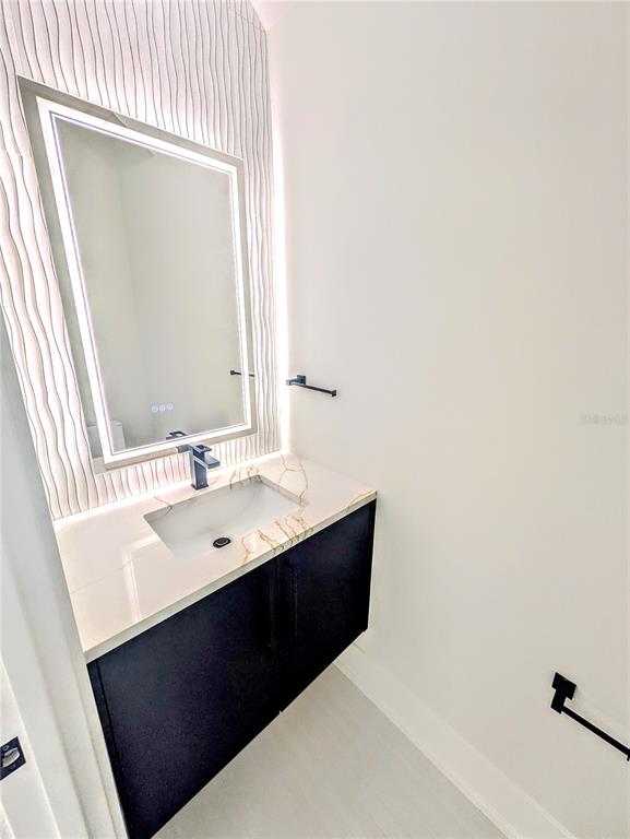 2194 Fruitville Road Sarasota, FL 34237 - Photo 14 of 32 a bathroom with a sink vanity and a mirror
