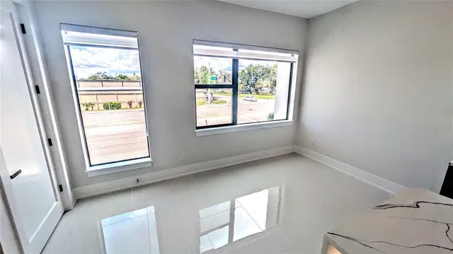 a view of an empty room and a window