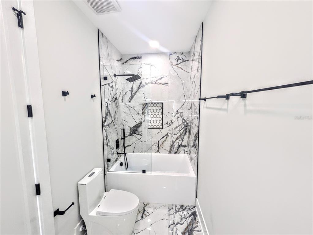2194 Fruitville Road Sarasota, FL 34237 - Photo 19 of 32 a bathroom with a toilet and a shower