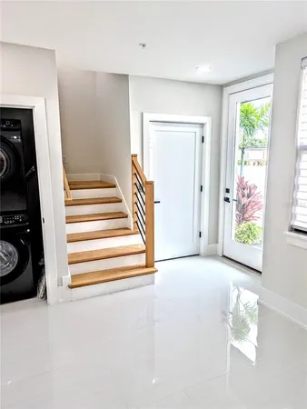 a view of a hallway with closet and a window
