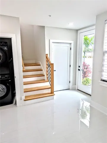 a view of a hallway with closet and a window