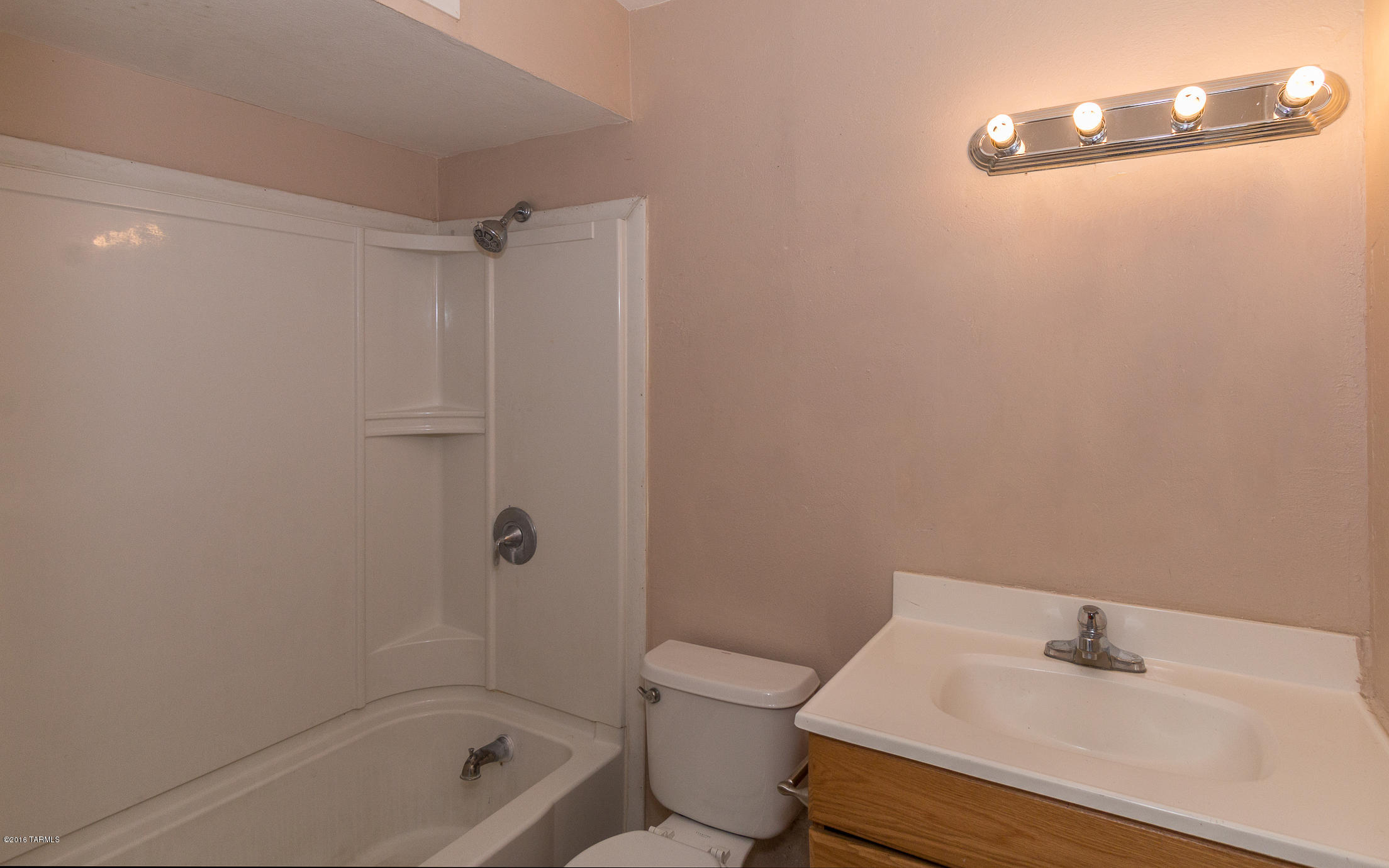 1807 West Merlin Road Tucson, AZ 85713 - Photo 28 of 34 a bathroom with a sink a toilet and shower