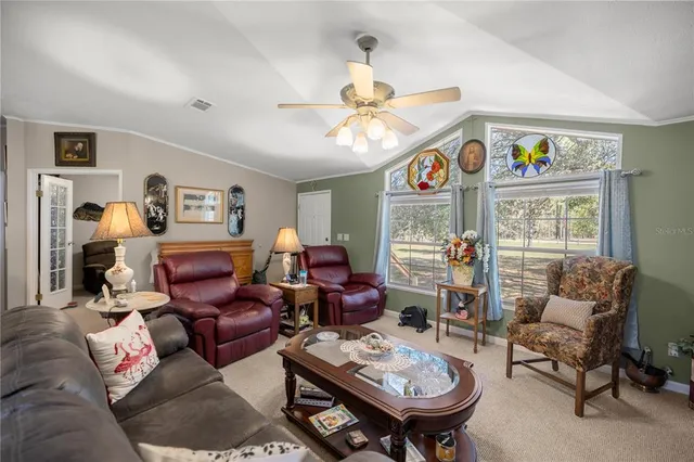 a living room with furniture a chandelier and a window