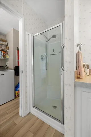 a bathroom with a shower and a sink