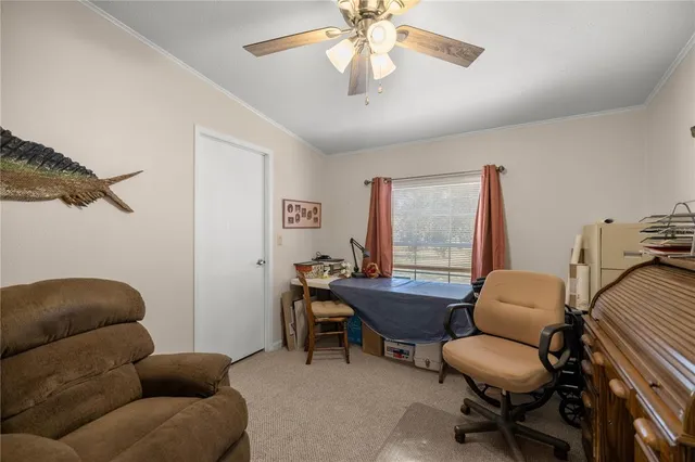 a livingroom with workspace couch and a window