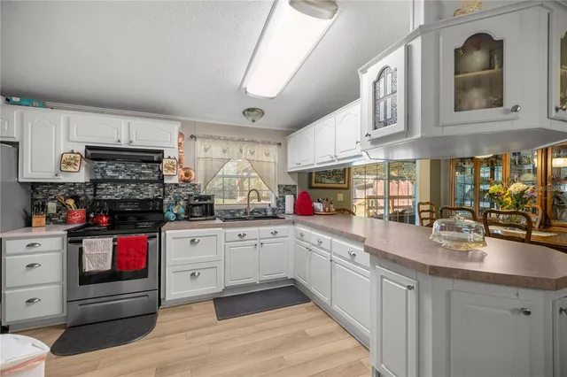 a kitchen with stainless steel appliances granite countertop a sink and cabinets