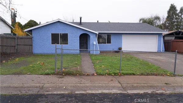 a front view of a house with a garden and yard