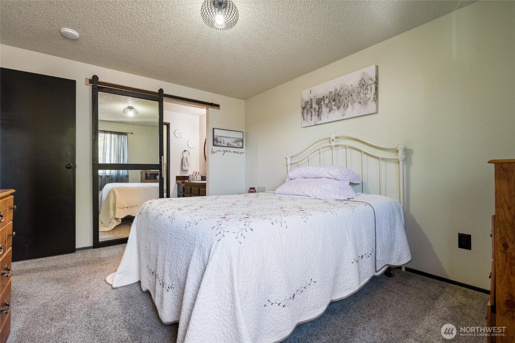 3560 Narrows View Lane Northeast, Unit 202 Bremerton, WA 98310 - Photo 20 of 27 a bedroom with a bed and a large mirror