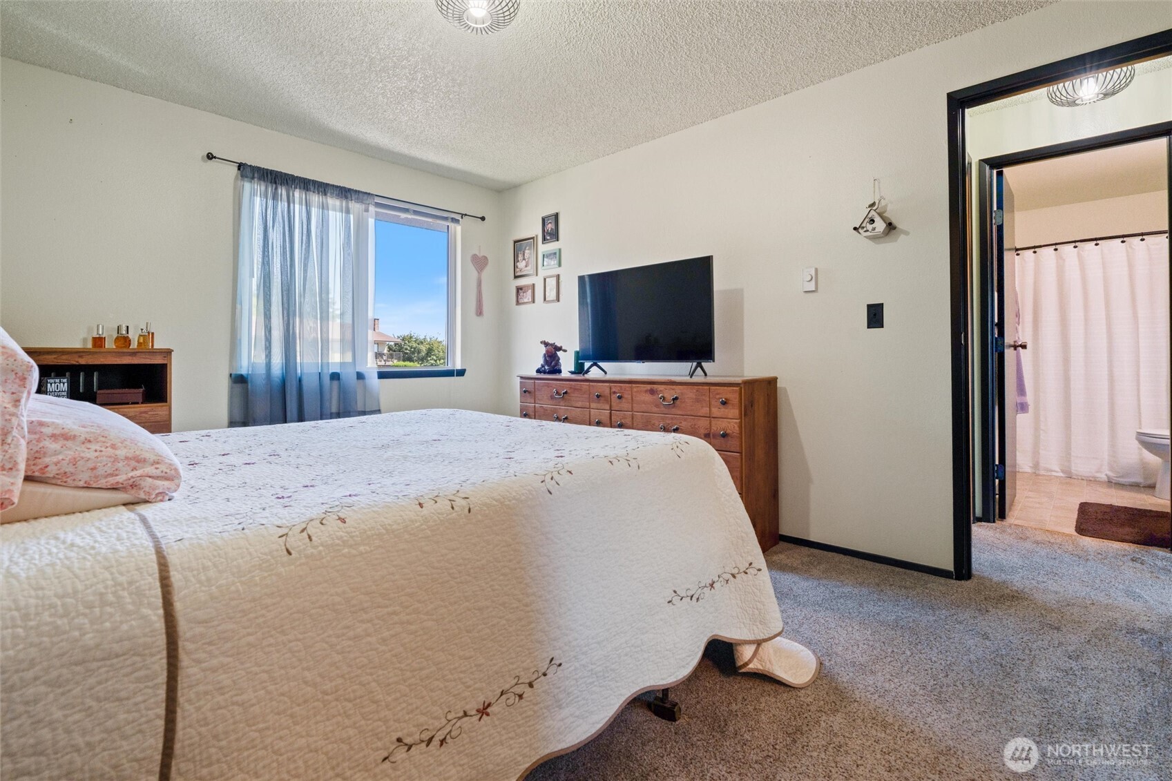 3560 Narrows View Lane Northeast, Unit 202 Bremerton, WA 98310 - Photo 21 of 27 a bedroom with a bed and a flat screen tv