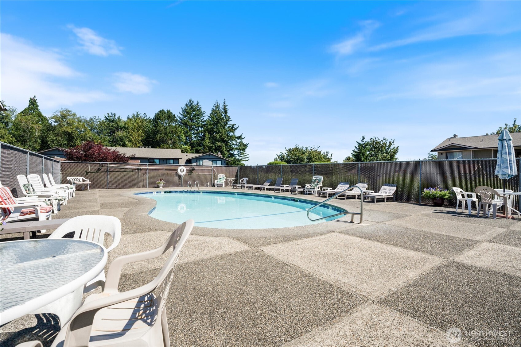3560 Narrows View Lane Northeast, Unit 202 Bremerton, WA 98310 - Photo 25 of 27 a view of a swimming pool with outdoor seating and plants