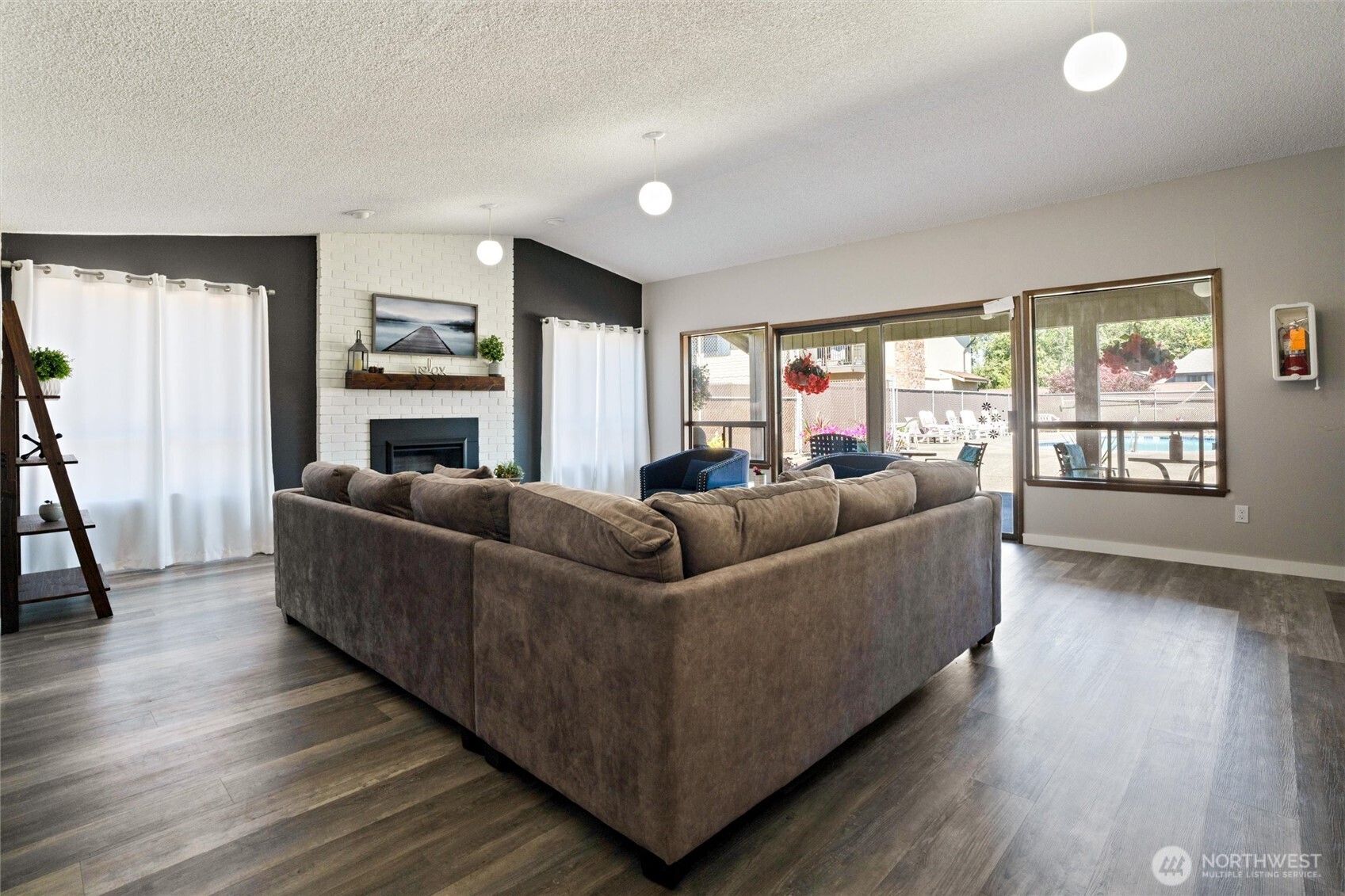 3560 Narrows View Lane Northeast, Unit 202 Bremerton, WA 98310 - Photo 26 of 27 a living room with furniture and a fireplace