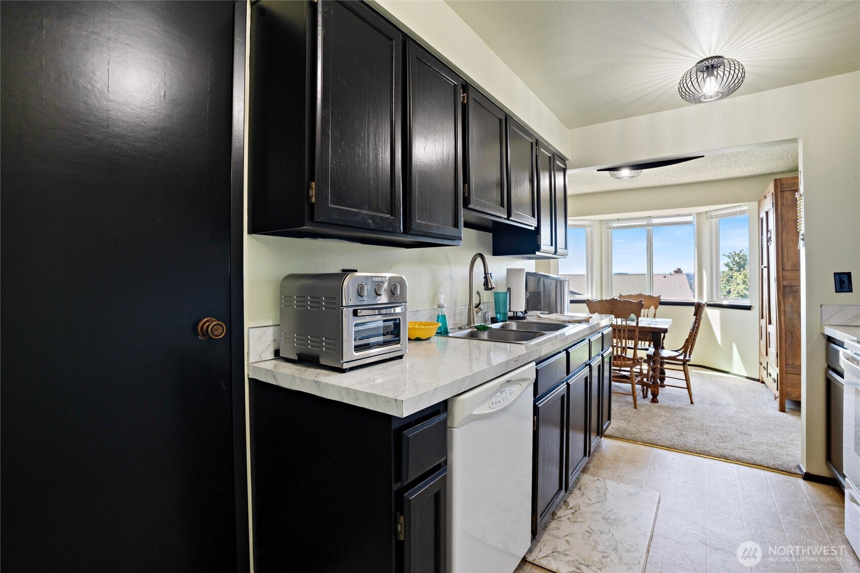 3560 Narrows View Lane Northeast, Unit 202 Bremerton, WA 98310 - Photo 7 of 27 a kitchen with a sink appliances and cabinets