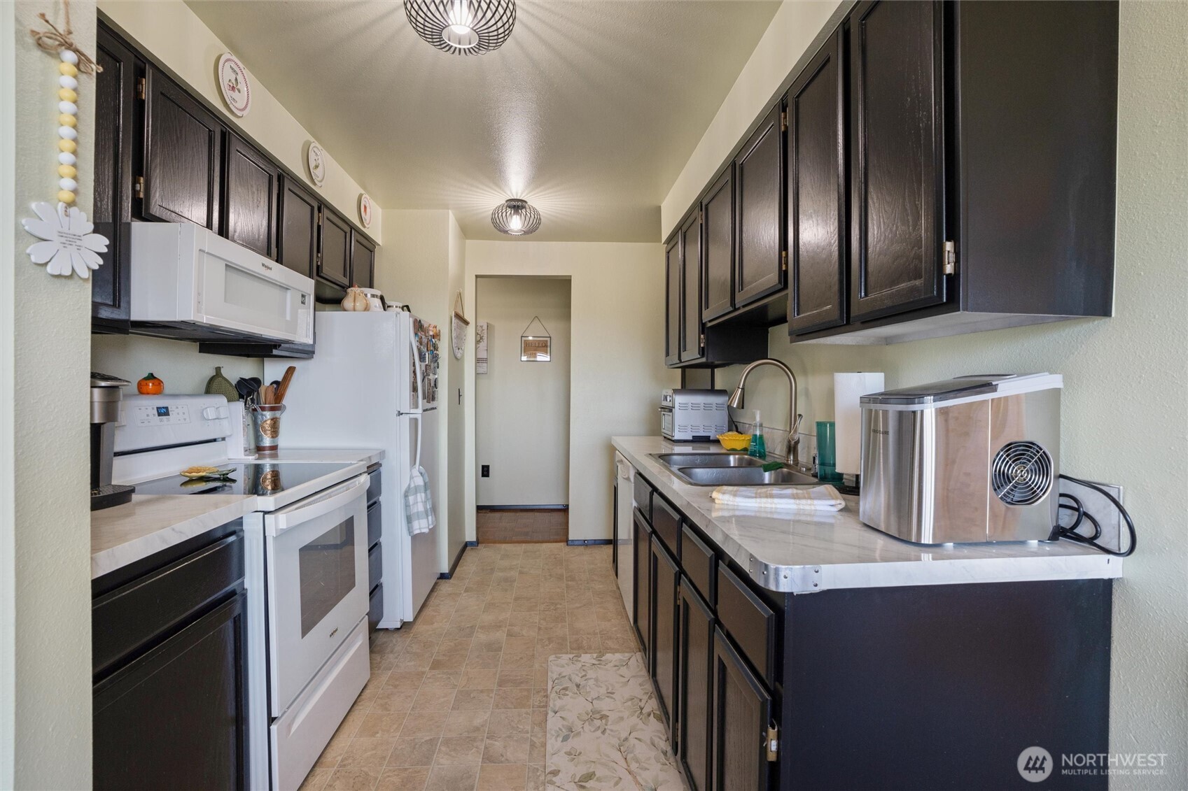 3560 Narrows View Lane Northeast, Unit 202 Bremerton, WA 98310 - Photo 9 of 27 a kitchen with a stove a refrigerator and a sink