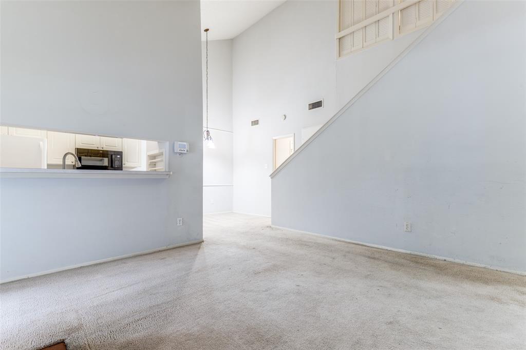 5981 Arapaho Road, Unit 1106 Dallas, TX 75248 - Photo 2 of 12 a view of a kitchen with white cabinets
