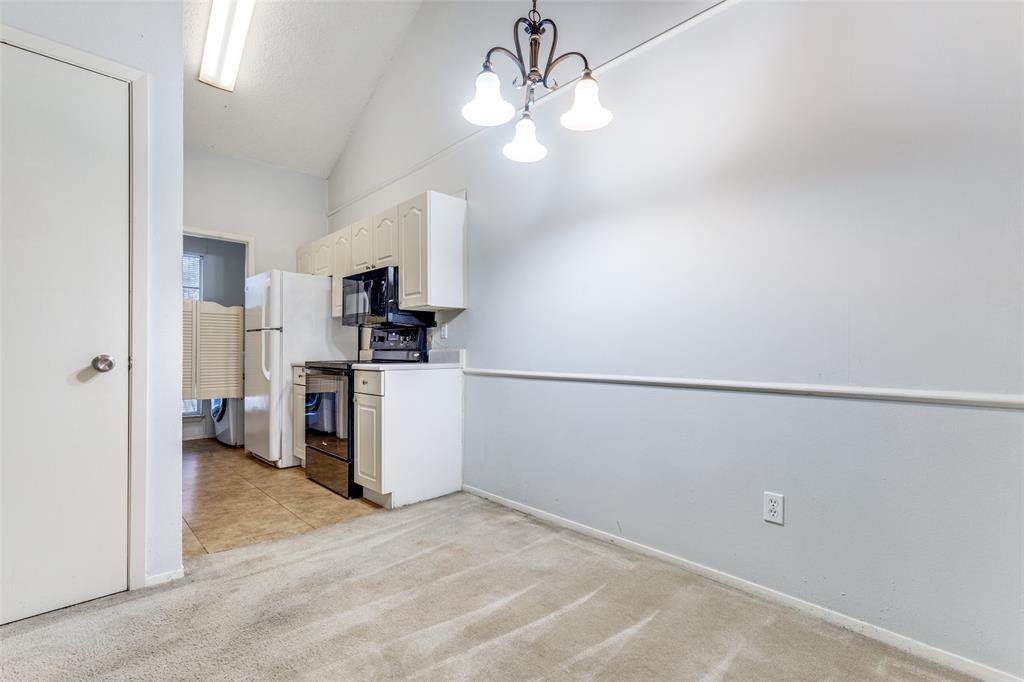 5981 Arapaho Road, Unit 1106 Dallas, TX 75248 - Photo 3 of 12 a view of a kitchen with a sink refrigerator and cabinets