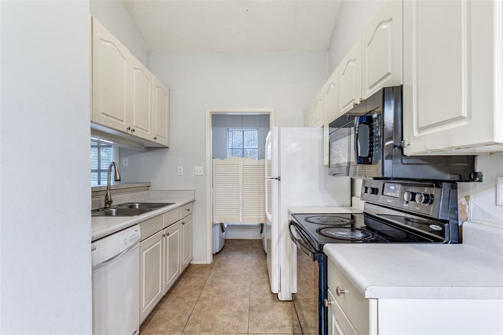5981 Arapaho Road, Unit 1106 Dallas, TX 75248 - Photo 5 of 12 a kitchen with stainless steel appliances a sink stove and cabinets