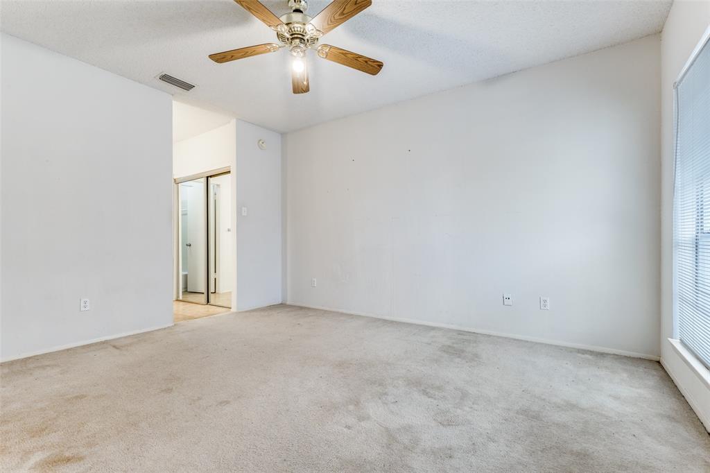 5981 Arapaho Road, Unit 1106 Dallas, TX 75248 - Photo 6 of 12 an empty room with windows and chandelier fan