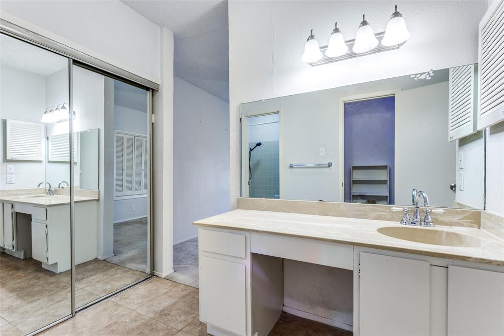 5981 Arapaho Road, Unit 1106 Dallas, TX 75248 - Photo 7 of 12 a bathroom with a sink vanity and a mirror
