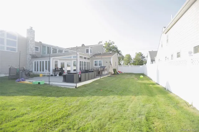 a view of a house with a yard and sitting area