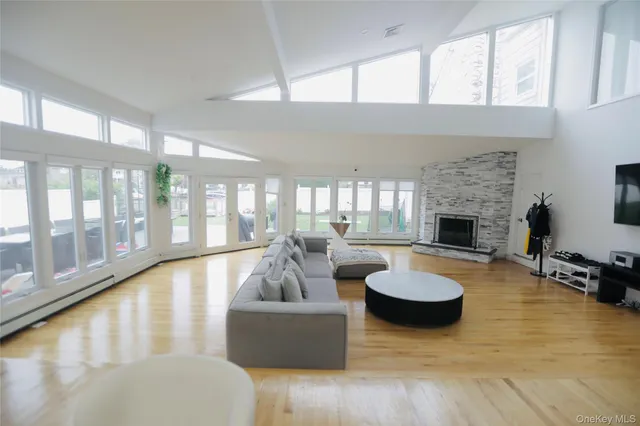 a living room with fireplace furniture and a large window