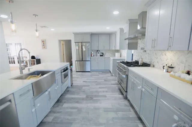 a large kitchen with stainless steel appliances lots of counter space sink and cabinets
