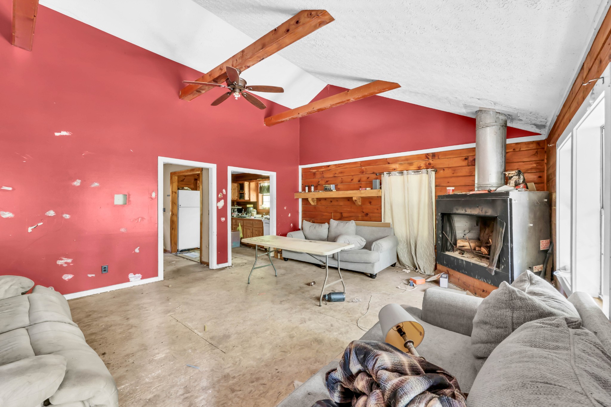 348 Shepherd Hollow Road Indian Mound, TN 37079 - Photo 9 of 23 a living room with furniture a fireplace and a floor to ceiling window