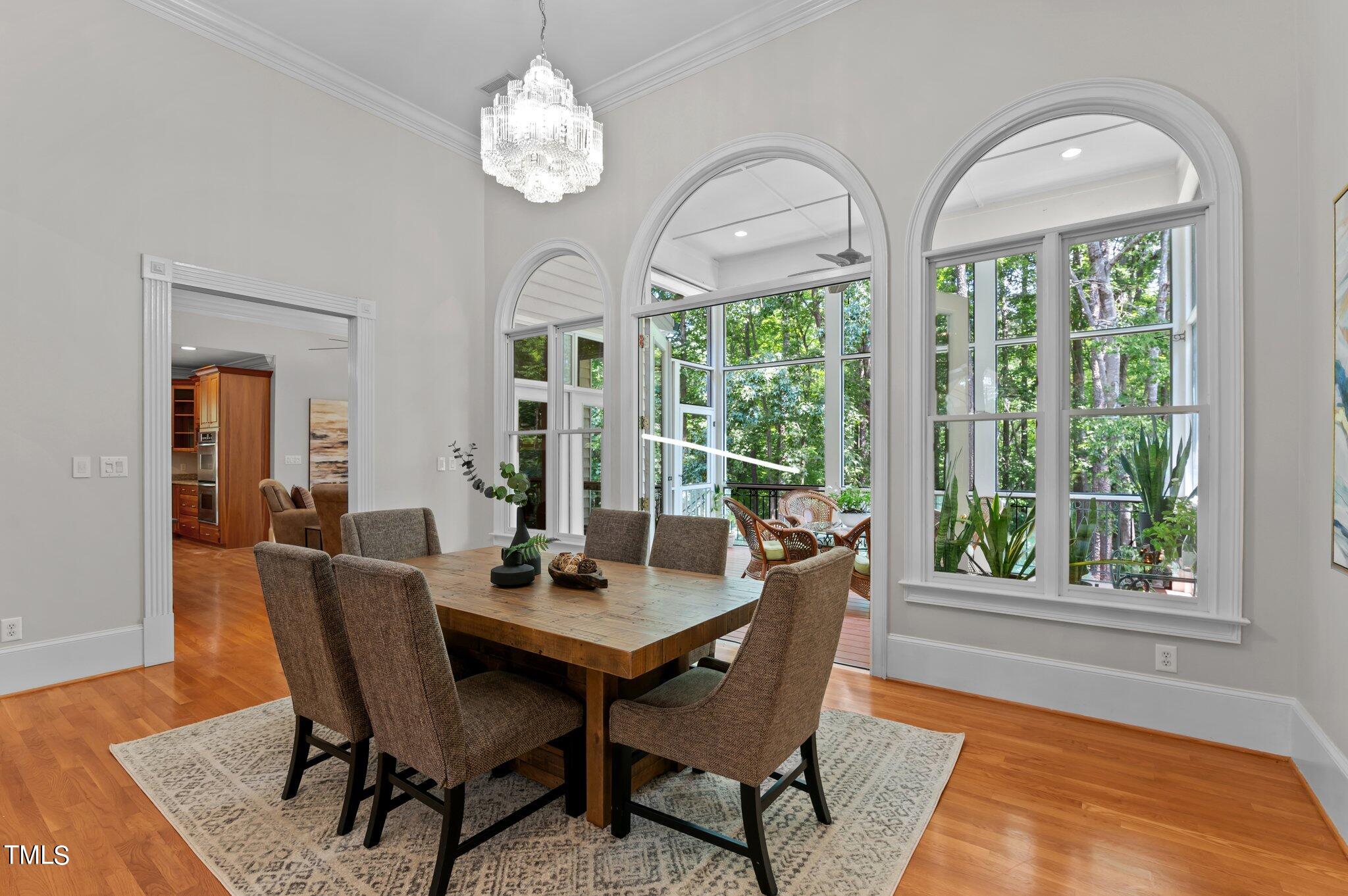 11112 Brass Kettle Road Raleigh, NC 27614 - Photo 18 of 65 a dining room with furniture a rug and a large window
