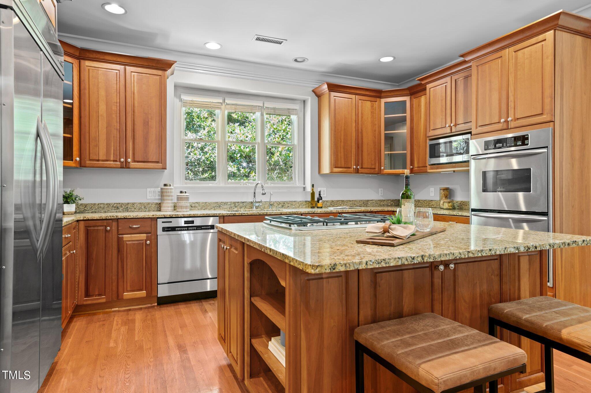 11112 Brass Kettle Road Raleigh, NC 27614 - Photo 23 of 65 a kitchen with stainless steel appliances granite countertop a stove a sink and a microwave