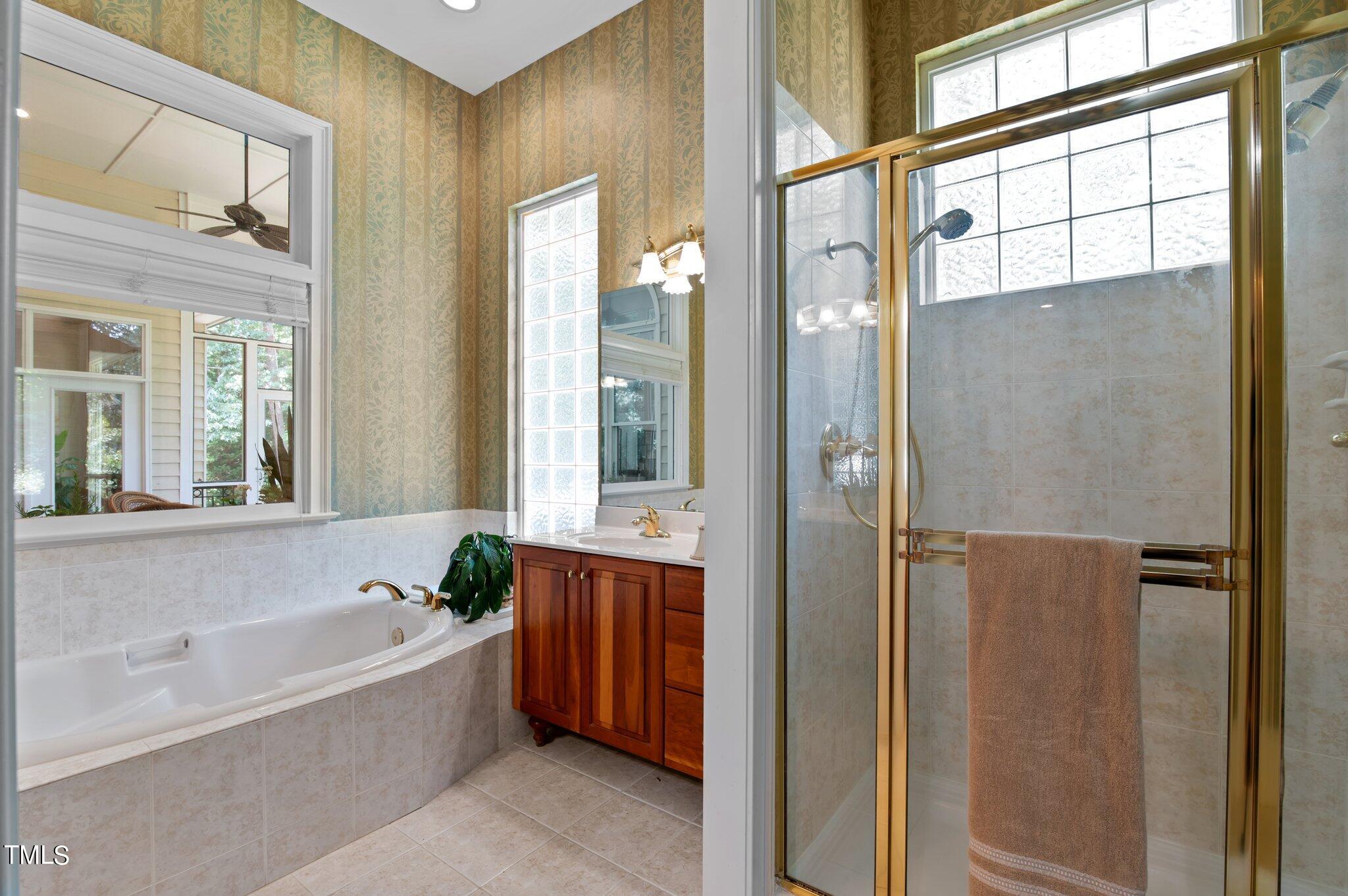 11112 Brass Kettle Road Raleigh, NC 27614 - Photo 33 of 65 a bathroom with a bathtub and shower