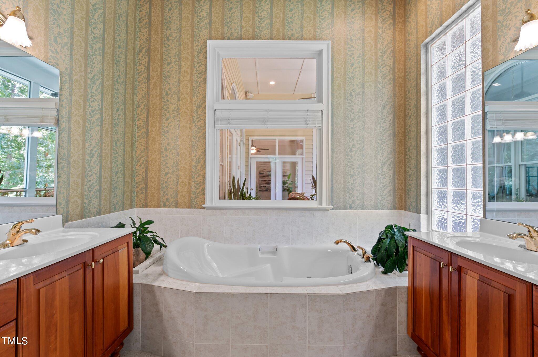 11112 Brass Kettle Road Raleigh, NC 27614 - Photo 34 of 65 a white bath tub sitting in a bathroom next to a window