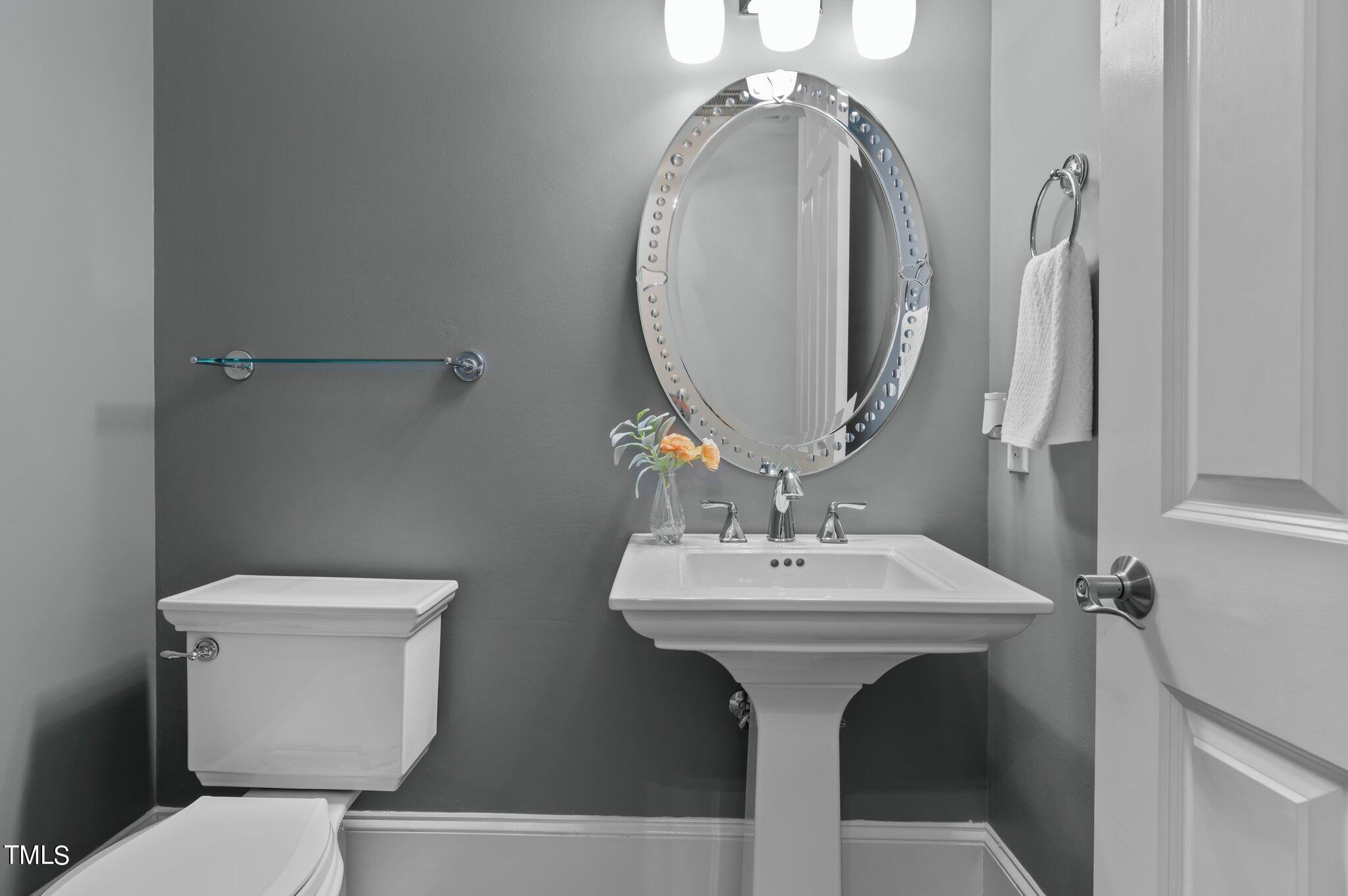 11112 Brass Kettle Road Raleigh, NC 27614 - Photo 40 of 65 a bathroom with a sink a toilet and a mirror