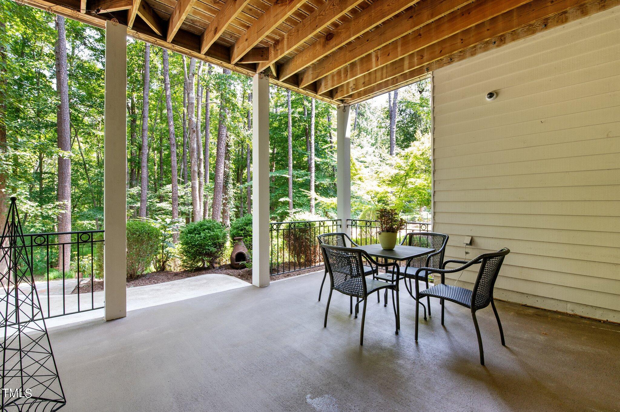 11112 Brass Kettle Road Raleigh, NC 27614 - Photo 44 of 65 a view of a patio with table and chairs and floor to ceiling window