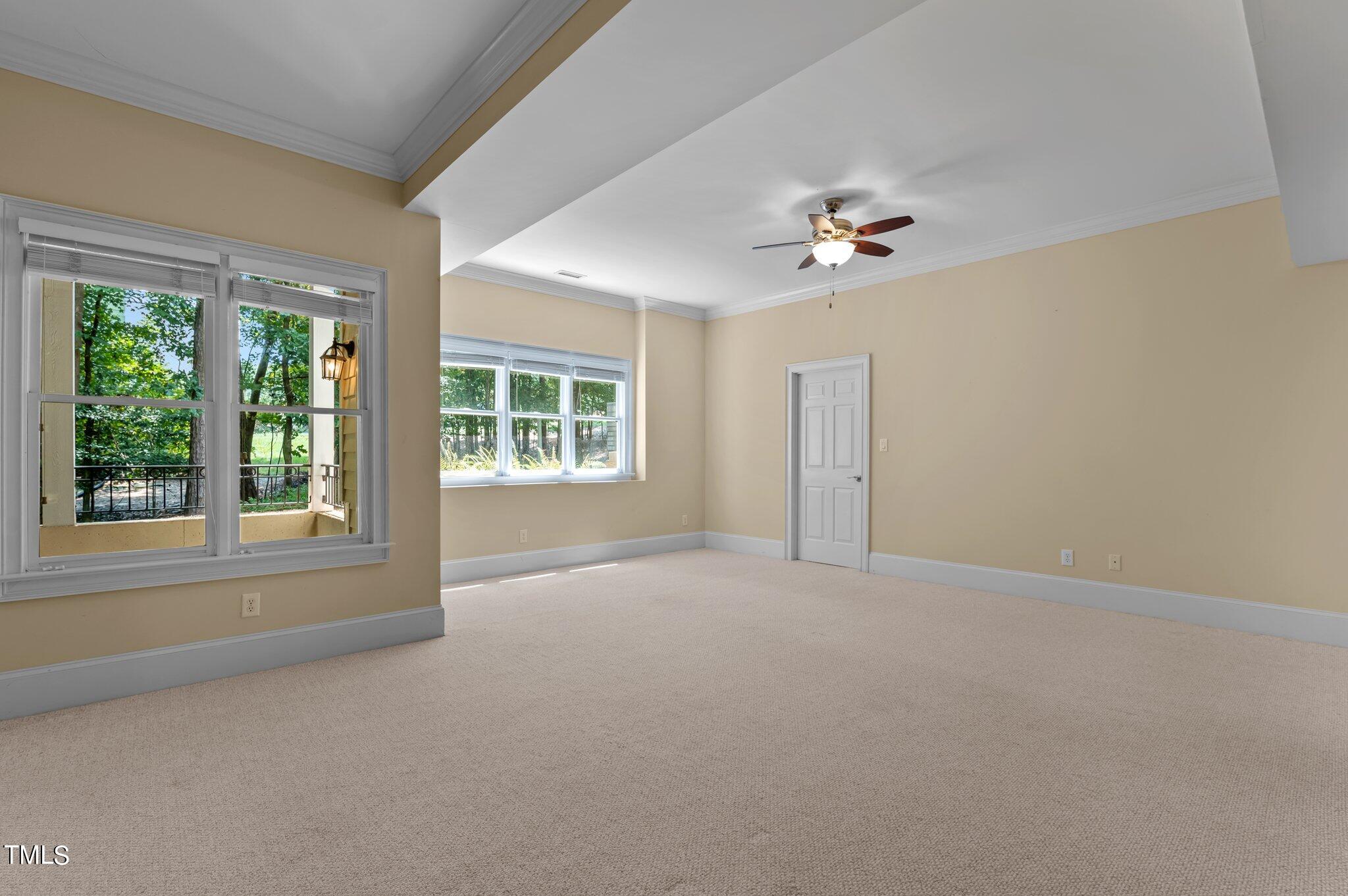 11112 Brass Kettle Road Raleigh, NC 27614 - Photo 57 of 65 an empty room with windows and ceiling fan