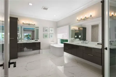 a large bathroom with a large tub and sink