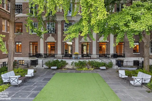 a view of a patio with table and chairs and potted plants