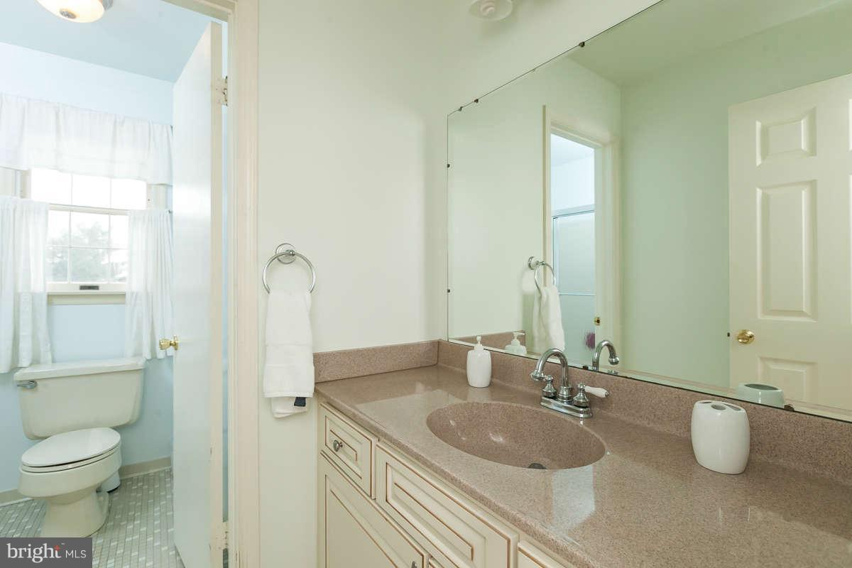 1769 Florence Road Mount Airy, MD 21771 - Photo 22 of 30 a bathroom with a granite countertop sink a toilet a mirror and shower